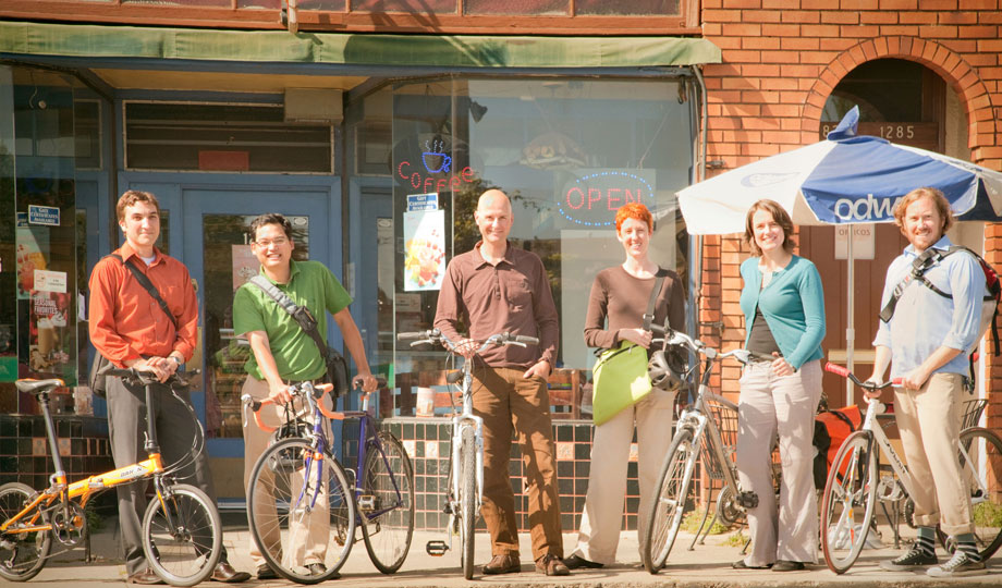 Early team standing with bicycles in front of the office on Gilman Street.