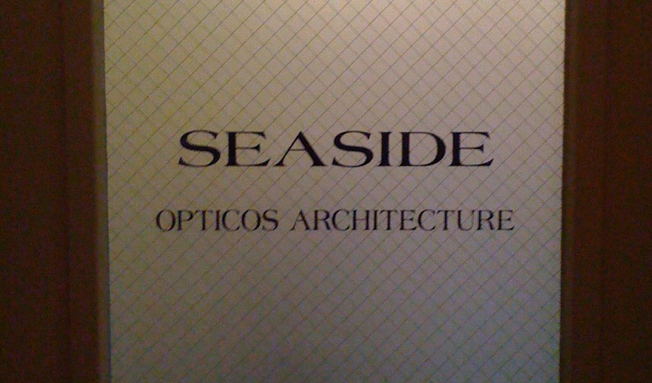 Lettering on an office doorway with the words: Seaside, Opticos Architecture