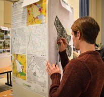 A workshop participant adds notes to a map.